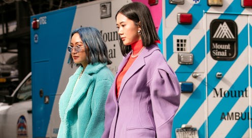 NYFW Street Style purple and light blue coats worn by two girls