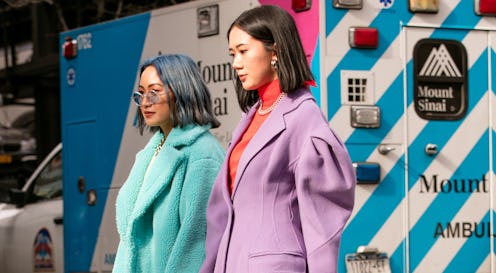 NYFW Street Style purple and light blue coats worn by two girls