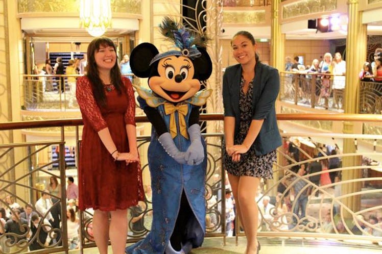 Two friends pose with Minnie Mouse in formal attire on a Disney Cruise.