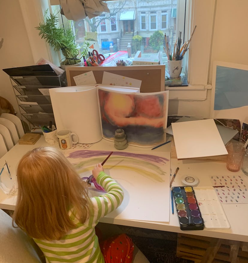 A young girl paints.