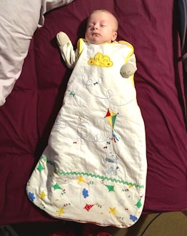 a toddler sleeps in a sleepsack