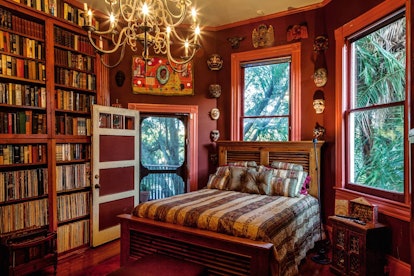 A bedroom in a New Orleans Airbnb has books on the shelves, just like the library from 'Beauty and t...