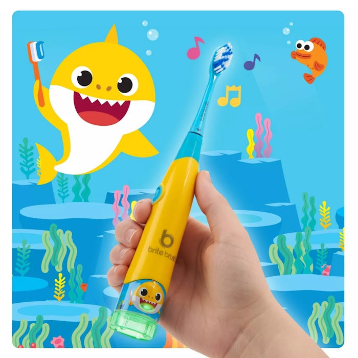 Brite Brush baby shark toothbrush in front of cartoon ocean background