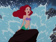 Ariel from 'The Little Mermaid' sings 'Part of Your World' on a rock with the waves crashing behind ...
