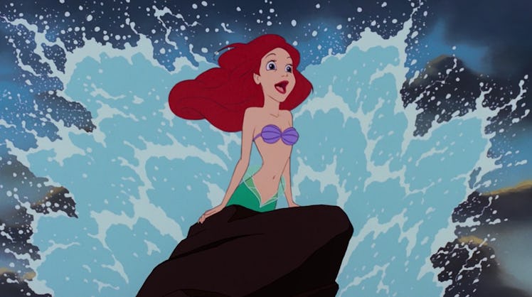 Ariel from 'The Little Mermaid' sings 'Part of Your World' on a rock with the waves crashing behind ...