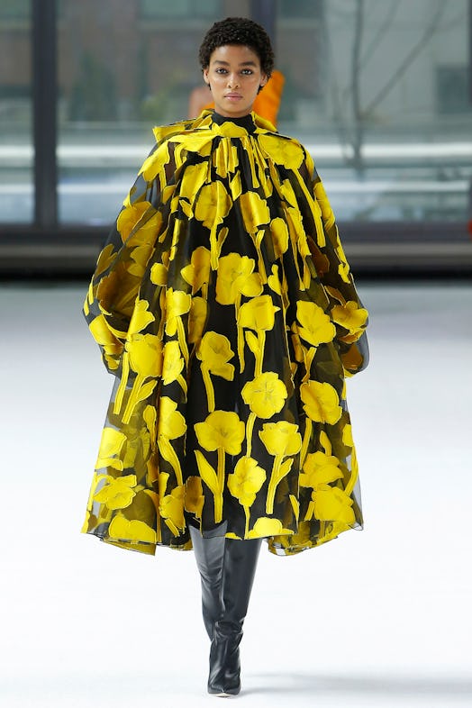 A model walking the runway in black-and-yellow floral-patterned dress from Carolina Herrera Fall/Win...