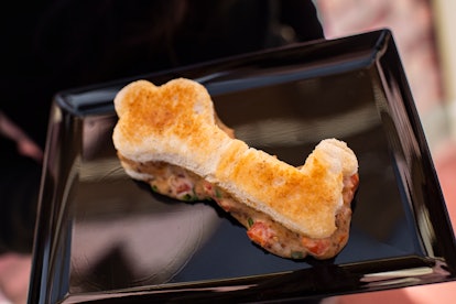 A key-shaped grilled cheese sandwich sits on a plate for the Disney Villains After Hours event. 