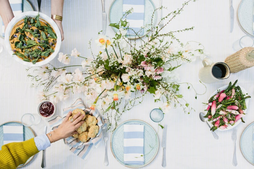 Dining table with colorful decor, local flowers, and repurposed arrangements.