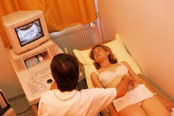 a woman has an ultrasound performed on her abdomen