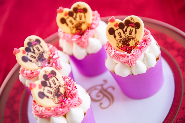 Mickey and Minnie-themed cupcakes sit on a plate for Valentine's Day at Disney. 