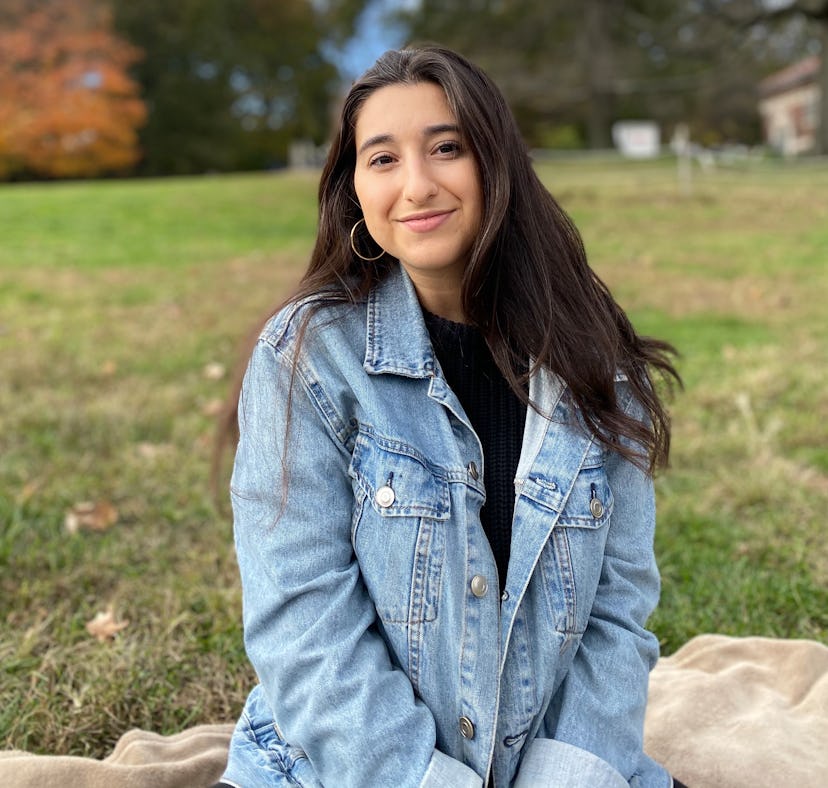 A Latinx writer Natasha Miñoso sitting outside.