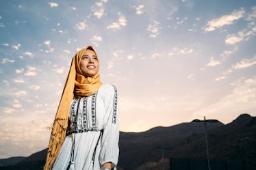 Young woman with headscarf and bright sky