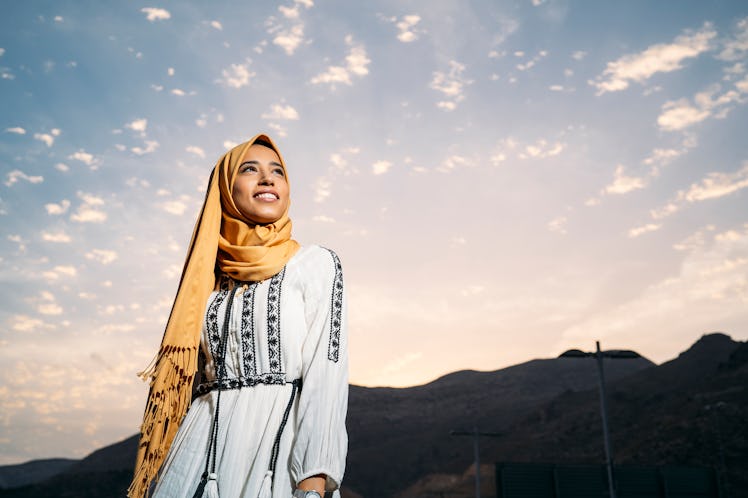 Young woman with headscarf and bright sky