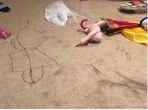A parent shared a photo of her playroom where her child wrote on the carpet.