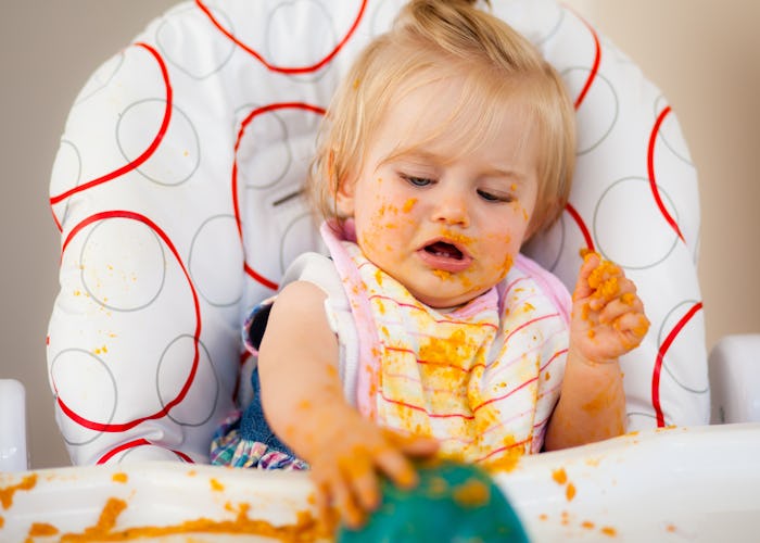 Blond toddler making a mess with food