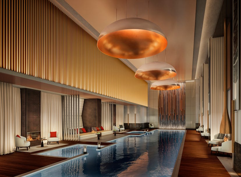 The swimming pool in  Aman New York: New York City, with large tall golden walls and ceiling