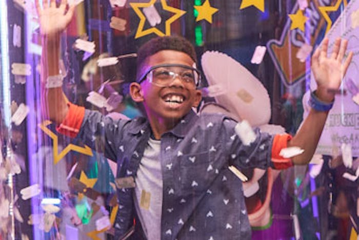 Boy plays in the wind tunnel at Chuck E. Cheese