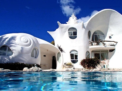 The World Famous Seashell House on Airbnb has a dreamy pool and white exterior that's incredibly bri...