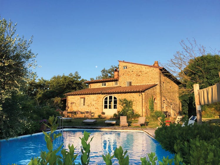 A stunning villa near Florence, Italy has a pool and glows in the midst of golden hour.