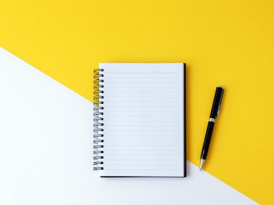 A notebook and a pen next to it for a to-do list 