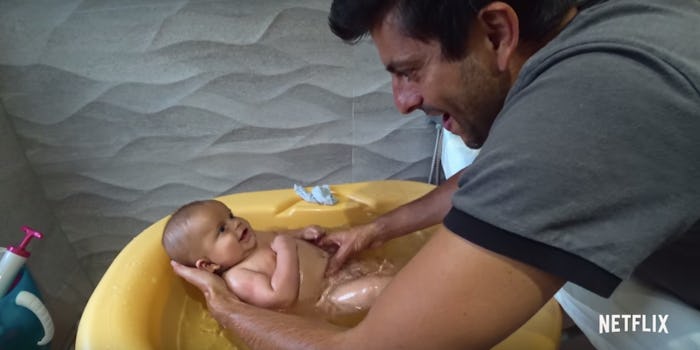 Father washes baby in a bath