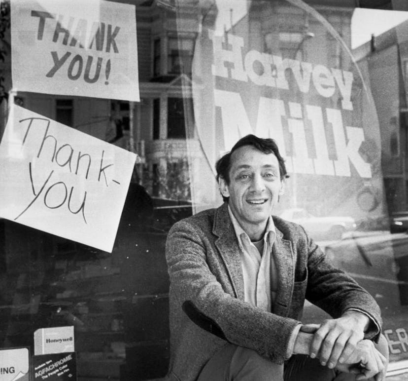 Supervisor Harvey Milk sits outside his camera shop in November 1977.