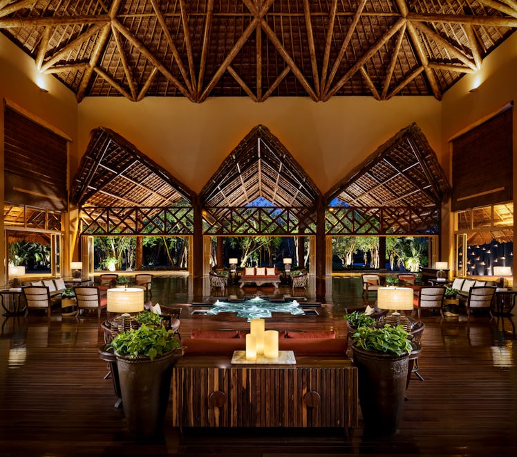 The lobby at Grand Velas Riviera Maya has an outdoorsy design and romantic atmosphere at night.