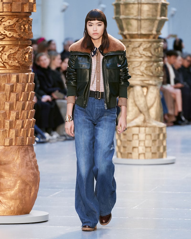A model in a black leather jacket and jeans walks the runway at chloe's fall 2020 show