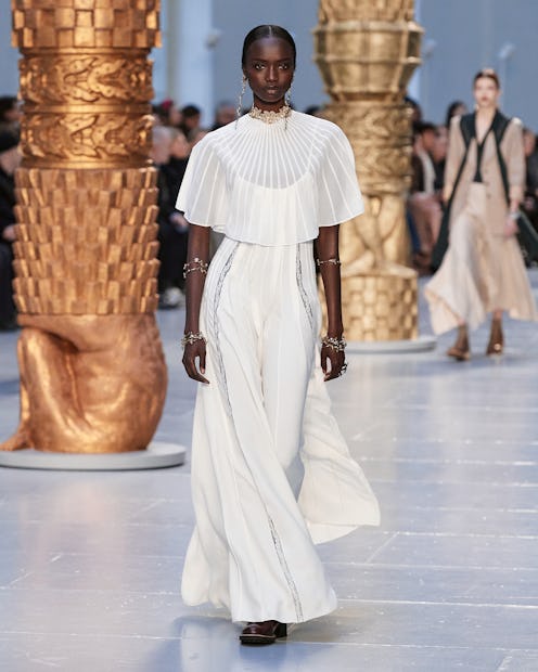 A model wearing a white dress walks the runway at chloe's fall 2020 show