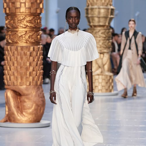 A model wearing a white dress walks the runway at chloe's fall 2020 show