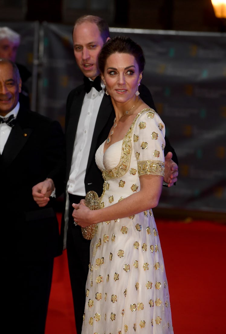 William going in to hug Kate around the waist on the red carpet at the BAFTAs