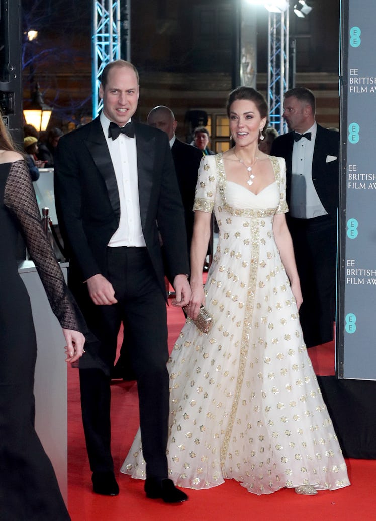 Prince William and Kate Middleton walking in step, close to each other on the red carpet