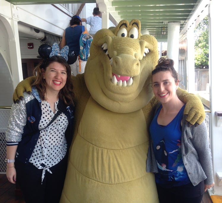 Two women pose for a pic with Louis the alligator from 'The Princess and the Frog' on the Mark Twain...