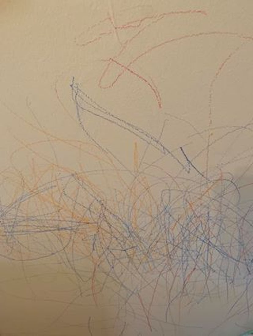 crayon marks scribbled all over a white wall