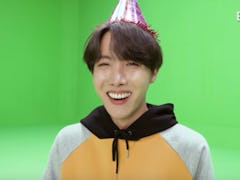 A screenshot from the video of BTS' J-Hope recreating his childhood birthday photo.