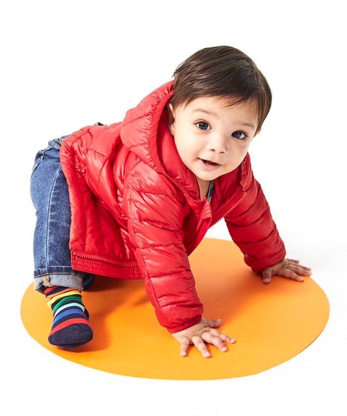 a baby wearing a red puffer jacket from primary