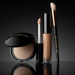 Pat McGrath Labs' Sublime Perfection Concealer System with powder, concealer, and brush.