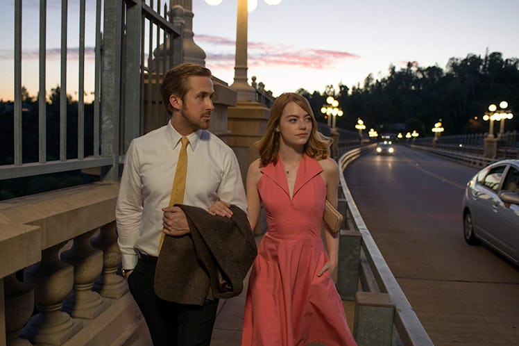 Ryan Gosling and Emma Stone walk down a street in Los Angeles during sunset in the romantic comedy '...