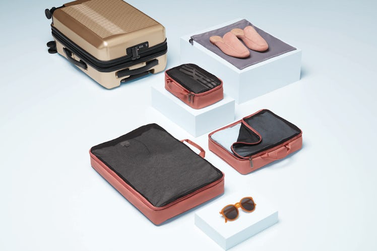 Target's Open Story luggage brand features easy-to-pack suitcases in different colors like gold and ...