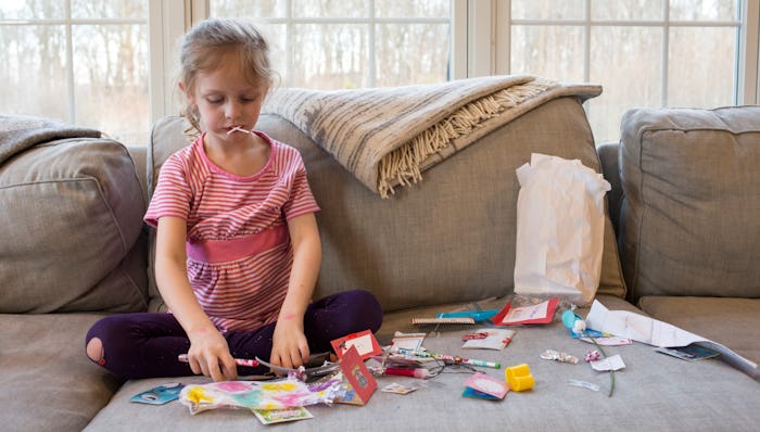 a little girl opening her valentines from school