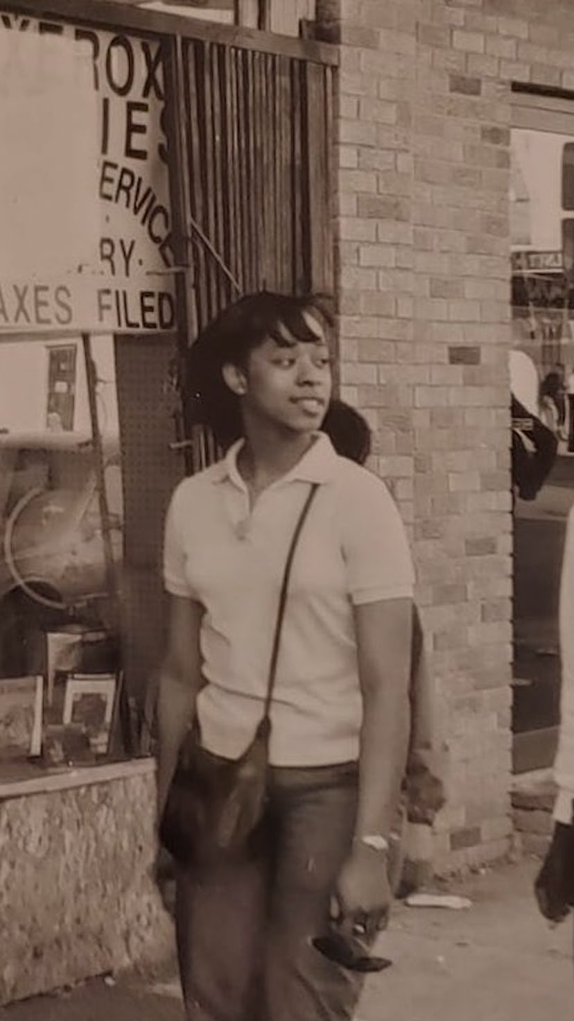 Two women walking next to a black-owned bookstore