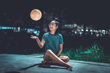 Young woman looking at supermoon