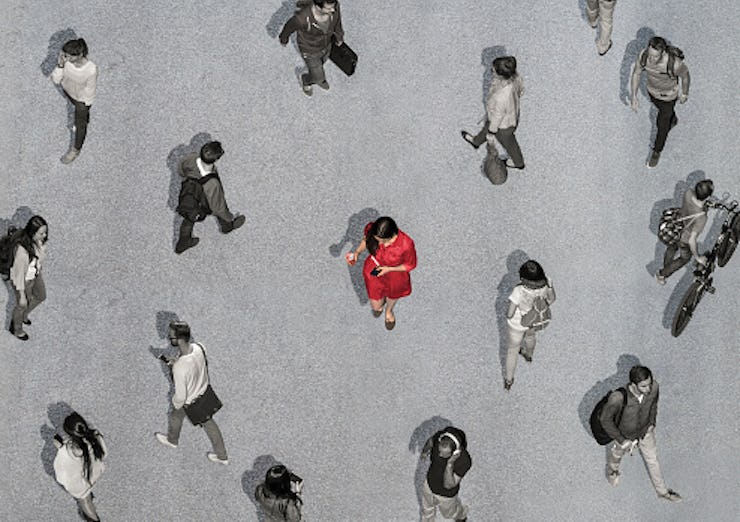 An illustration of a woman in a red dress surrounded by people in black and white