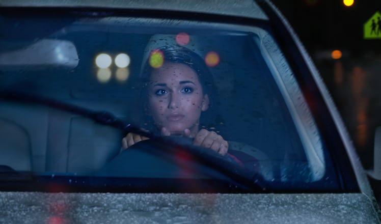 Young woman in car on Friday the 13th