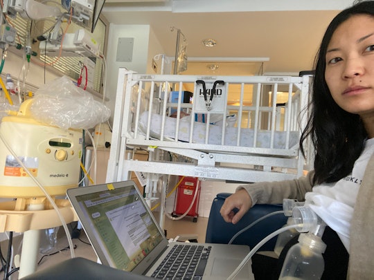 A mom pumps milk in a NICU while on her laptop