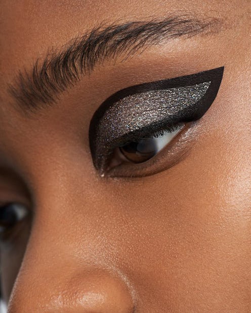Woman with matte black and glitter eyeshadow