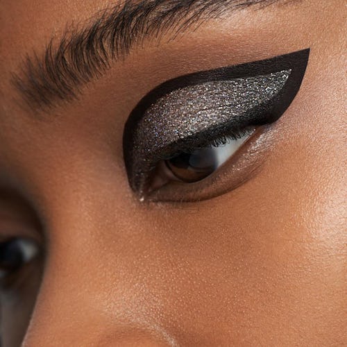 Woman with matte black and glitter eyeshadow