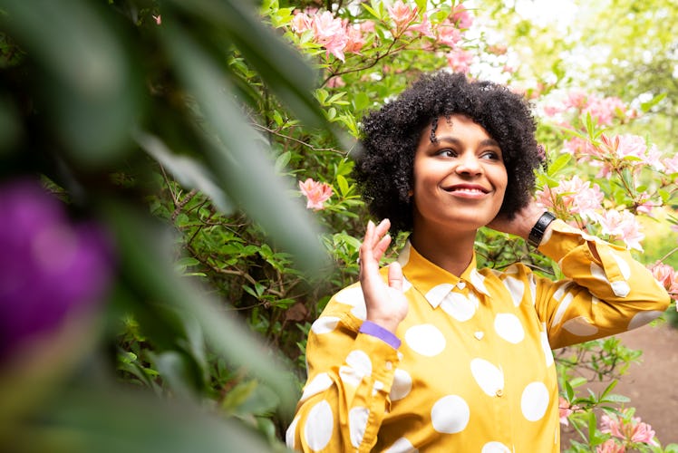 Young black woman in the park with flowers