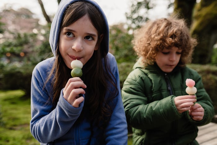 A sister and brother eat Mochi