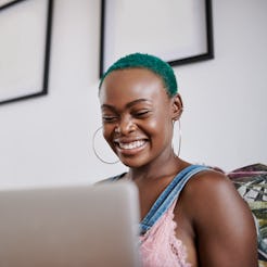 A woman with green hair copes with loneliness while working from home
